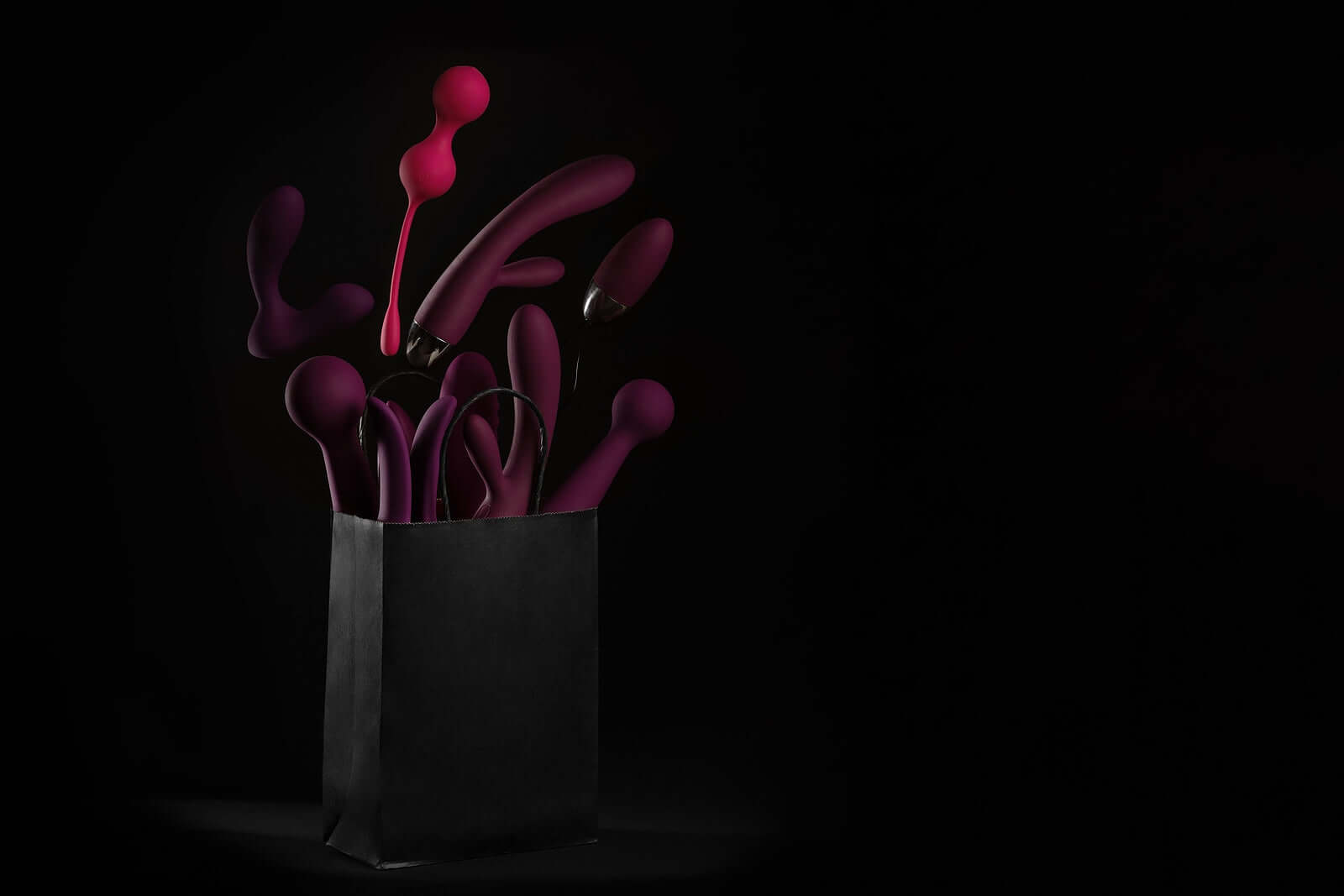 Vibrators, Massagers & Body collection featuring vibrant pleasure products in a stylish black bag.
