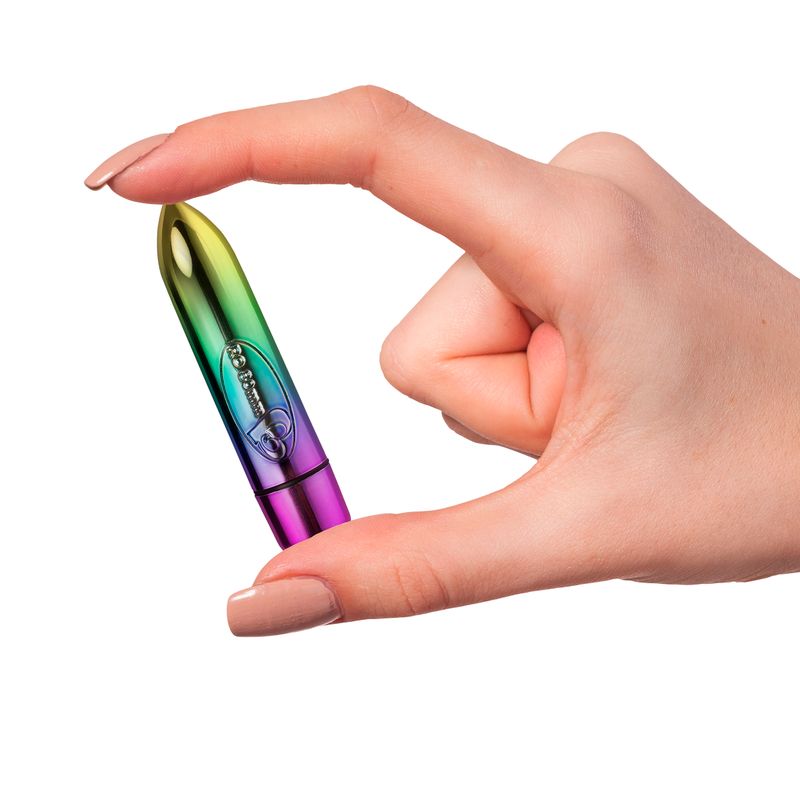 A hand holding the RO-80mm 7 speed vibrating pleasure bullet, showcasing its vibrant rainbow colors.