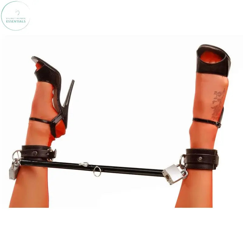 Adjustable steel spreader bar with cuffs and padlock holding legs in position, enhancing bondage play.