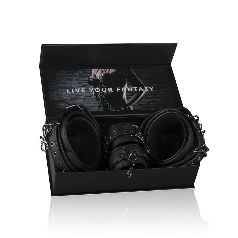 BDSM thigh and wrist cuff set displayed in an open box, showcasing durable black faux leather cuffs.