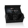 BDSM thigh and wrist cuff set displayed in an open box, showcasing durable black faux leather cuffs.