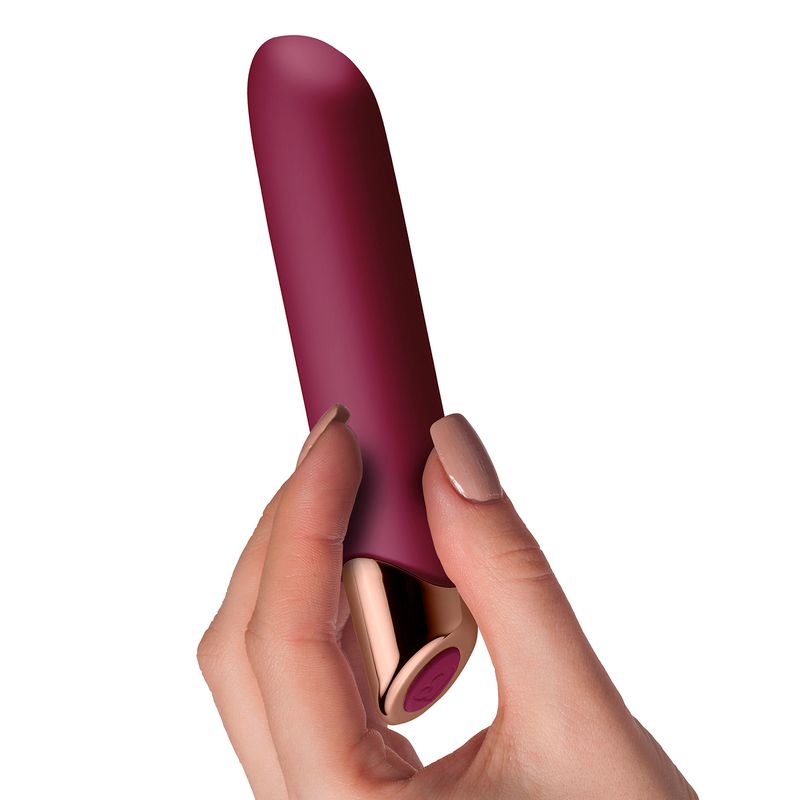 Chaiamo Rechargeable Burgundy held in hand, a luxurious rechargeable sensual massager designed for intense pleasure.