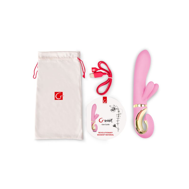 G-Rabbit Candy Pink G-spot vibrator with charging cable, storage pouch, and user guide.