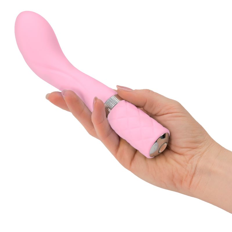 Sassy pink G-spot vibrator held in hand, showcasing its elegant curve and soft texture for pleasure.