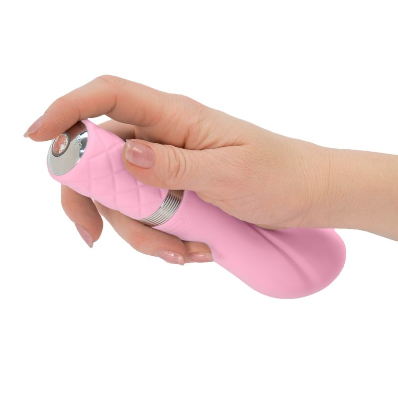 Hand holding the Pillow Talk Sassy Pink intimate toy, showcasing its elegant design and functionality.