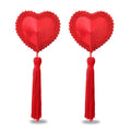 Reusable heart nipple pasties with red lace edge and tassels, perfect for sexy outfits or nipple cover ups.