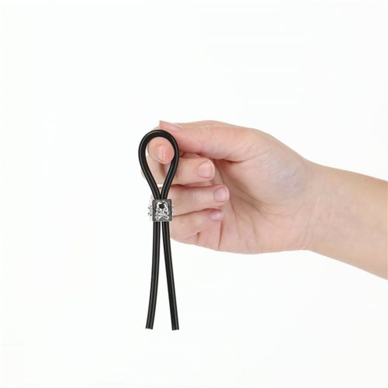 Tether Adjustable Cock Tie held in hand, showcasing premium silicone design for BDSM and intimate essentials.