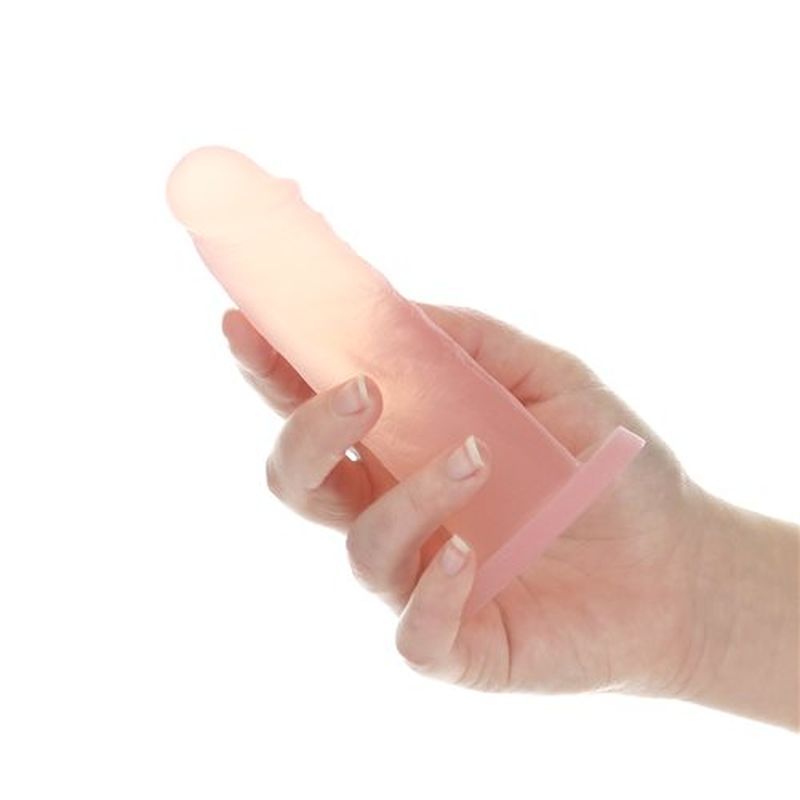 Peach Bellini dildo held in hand, showcasing its soft silicone texture and design.