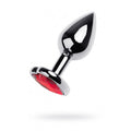Silver anal plug with ruby gem featuring a shiny finish and red heart gem detail, measuring 7cm in length.