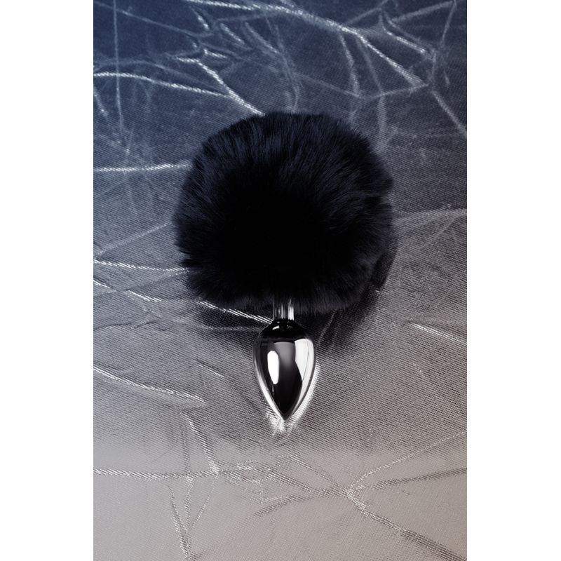 Silver anal plug with black tail featuring a sleek metal design and fluffy black faux fur.