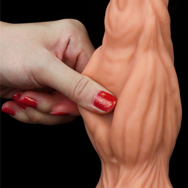 Close-up of a hand gripping the dual layer silicone dildo, showcasing its lifelike texture and details.
