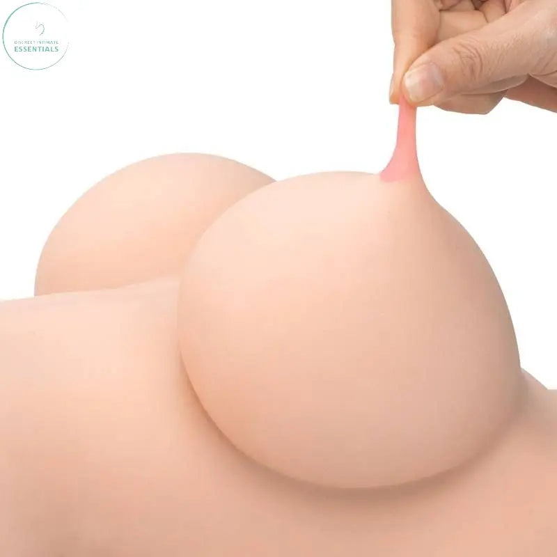 Close-up of a hand gently pulling the realistic soft breast of a female torso with natural skin tone.
