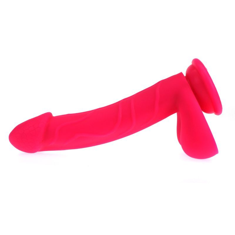 Realistic pink dildo with suction base featuring detailed texture and ergonomics.