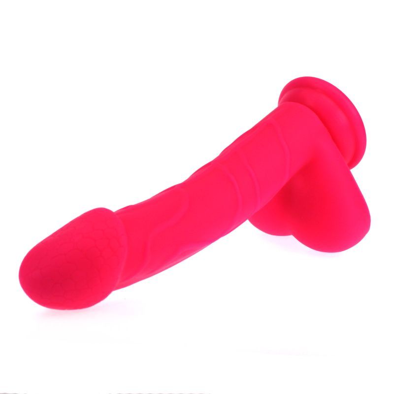 Realistic pink dildo with suction base featuring detailed texture and ball design, made from 100 percent silicone.