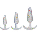 Rainbow anal trainer set featuring three silicone butt plugs in different sizes with colorful confetti design.