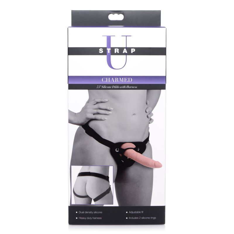 Charmed 7.5in silicone dildo with harness packaging, showing adjustable harness and sleek design.