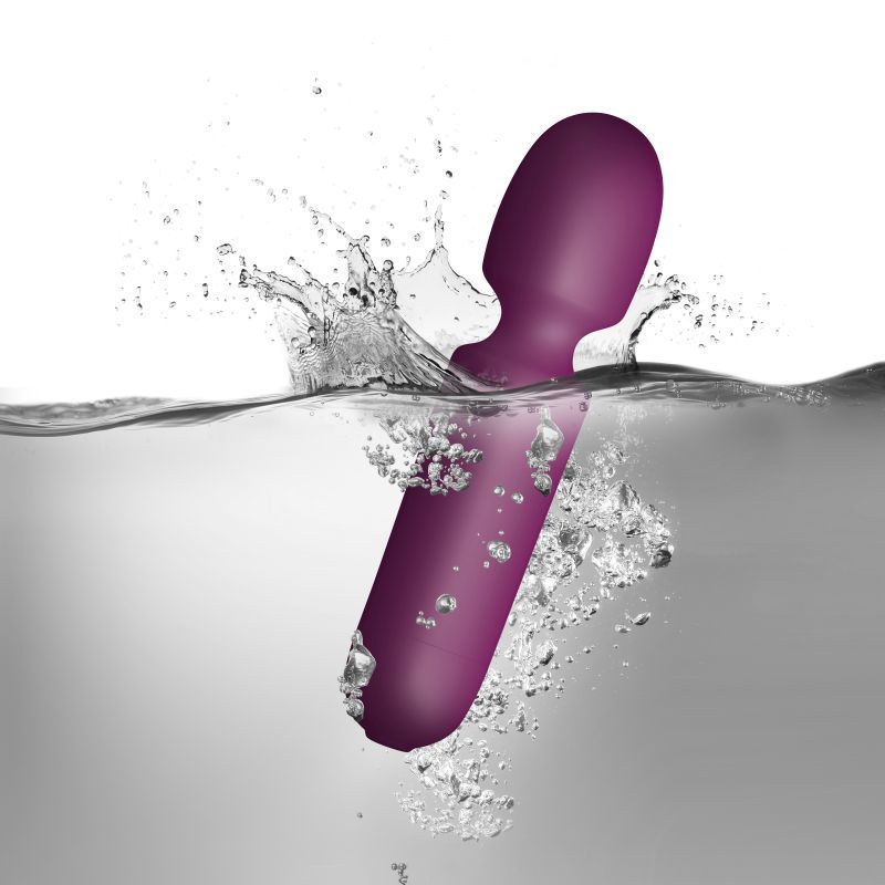Discreet wand vibrator splashing in water, showcasing the velvet touch and waterproof design.