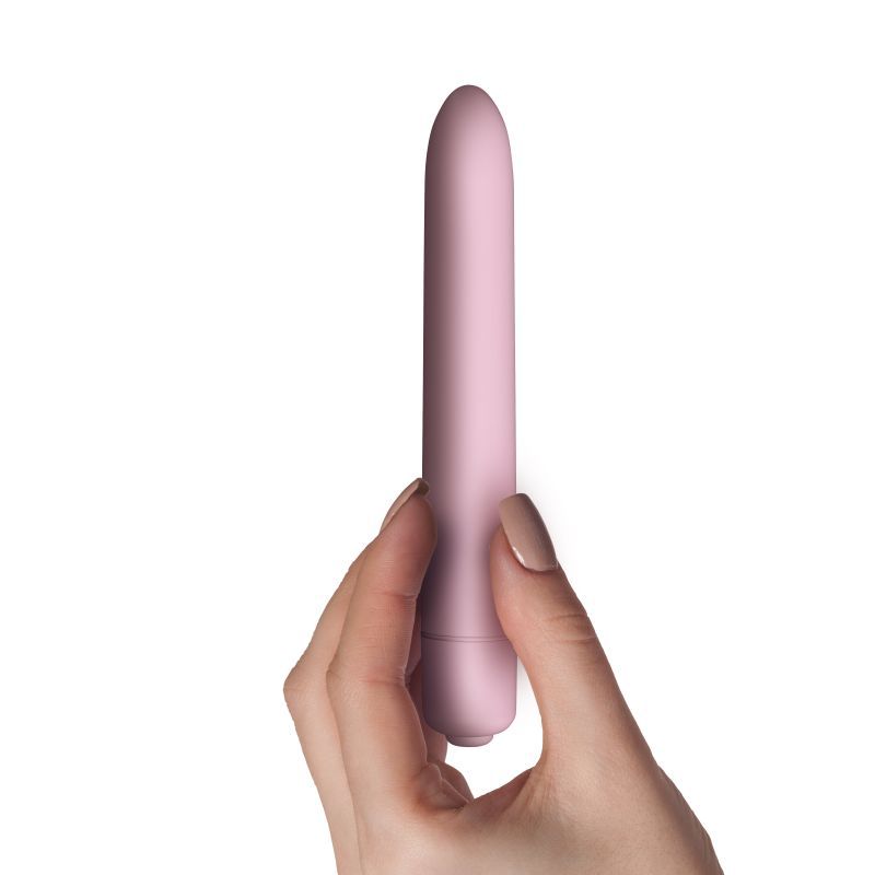 Hand holding the SugarBoo Bullet Vibe Pink, a waterproof bullet vibrator with pinpoint stimulation.