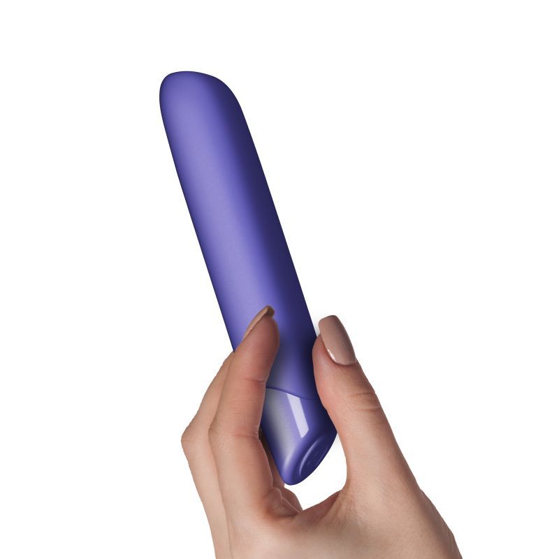 Hand holding the SugarBoo Very Peri vibrating bullet vibe, showcasing its sleek design and sensory touch surface.