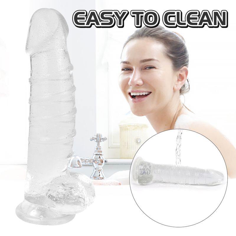 XXL clear dildo with balls next to a smiling woman, demonstrating easy cleaning and clear visibility.