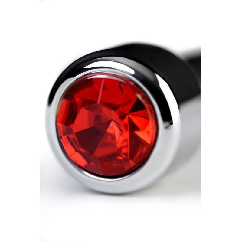 Close-up of a silver urethral plug with ruby rhinestone detail, showcasing its vibrant red gem and polished metal finish.