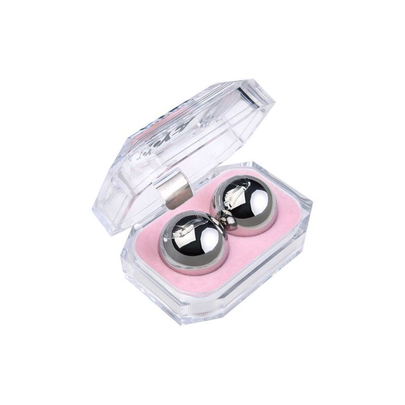 Silver metal vaginal balls in a transparent case with pink padding, showcasing their sleek design and premium quality.