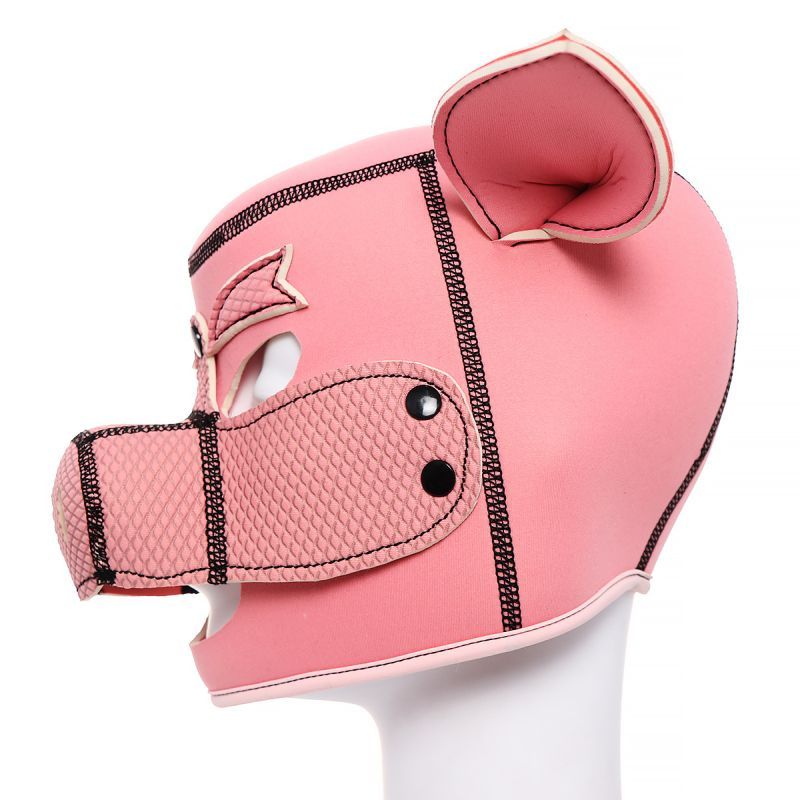 Side view of a pink neoprene pig mask with ears and detachable mouthpiece for comfort and visibility.