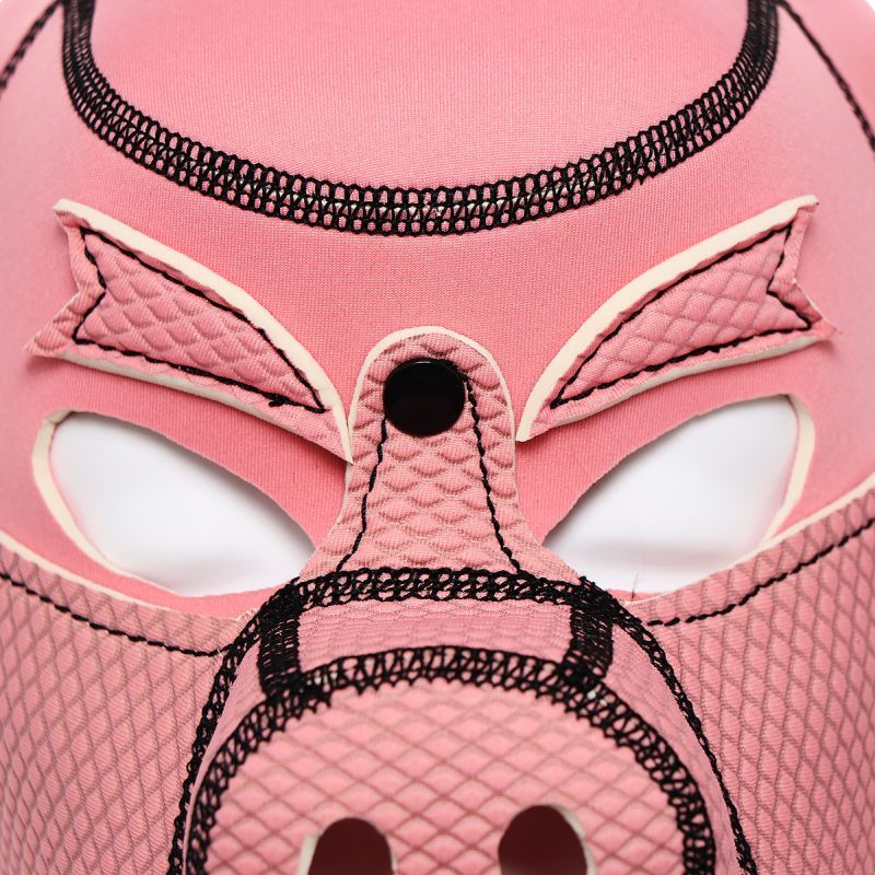 Close-up of a pink neoprene pig mask featuring detailed stitching and cut-out eyes for visibility.