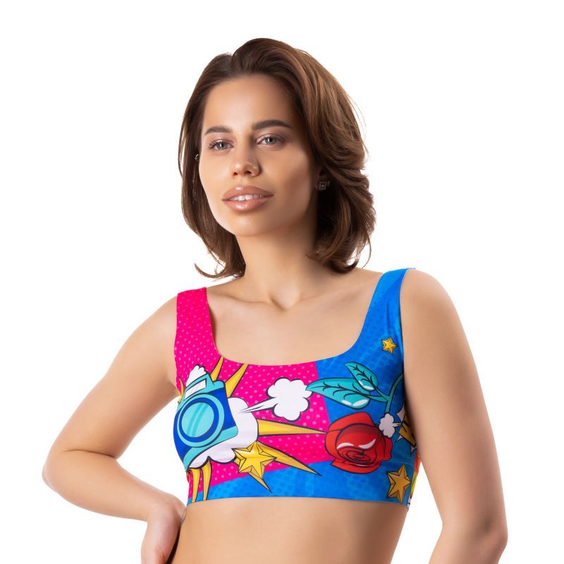 Model wearing a colorful Comics Curios Crop Top, showcasing bold graphics and a comfortable fit, perfect for lingerie.