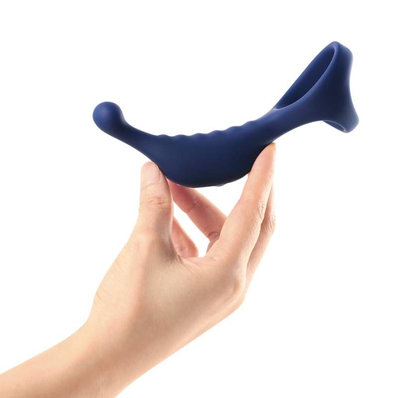 Hand holding the Underquaker vibrating anal probe with cockring, showcasing its ergonomic design and luxurious material.