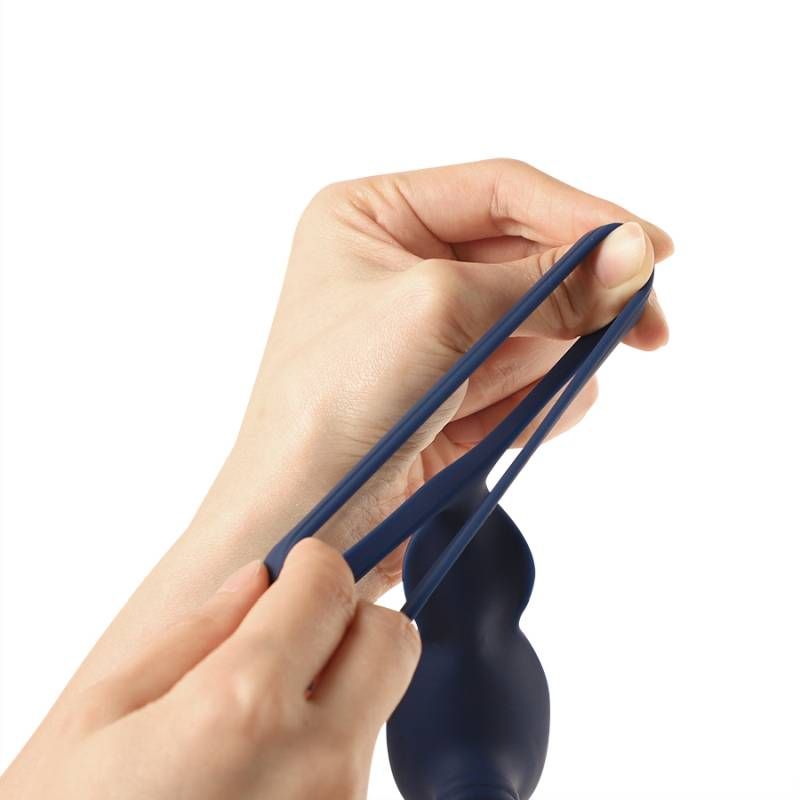 Person demonstrating the flexibility of a VibraDuo vibrating anal probe and cockring, showcasing its premium silicone material.