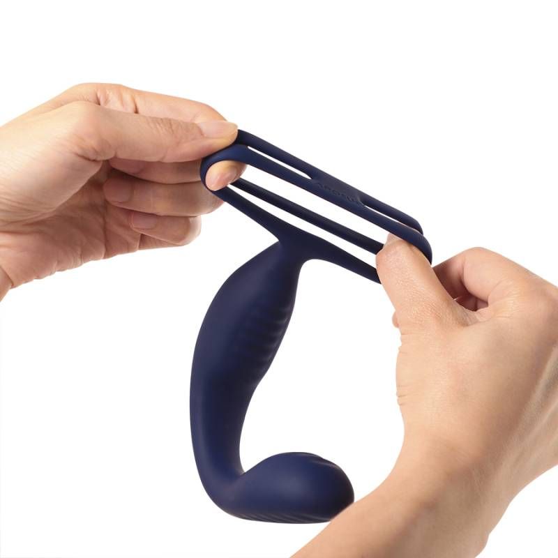 Person holding the VibraDuo Vibrating Anal Probe and Perineum Stim with Cockring, showcasing flexible design.