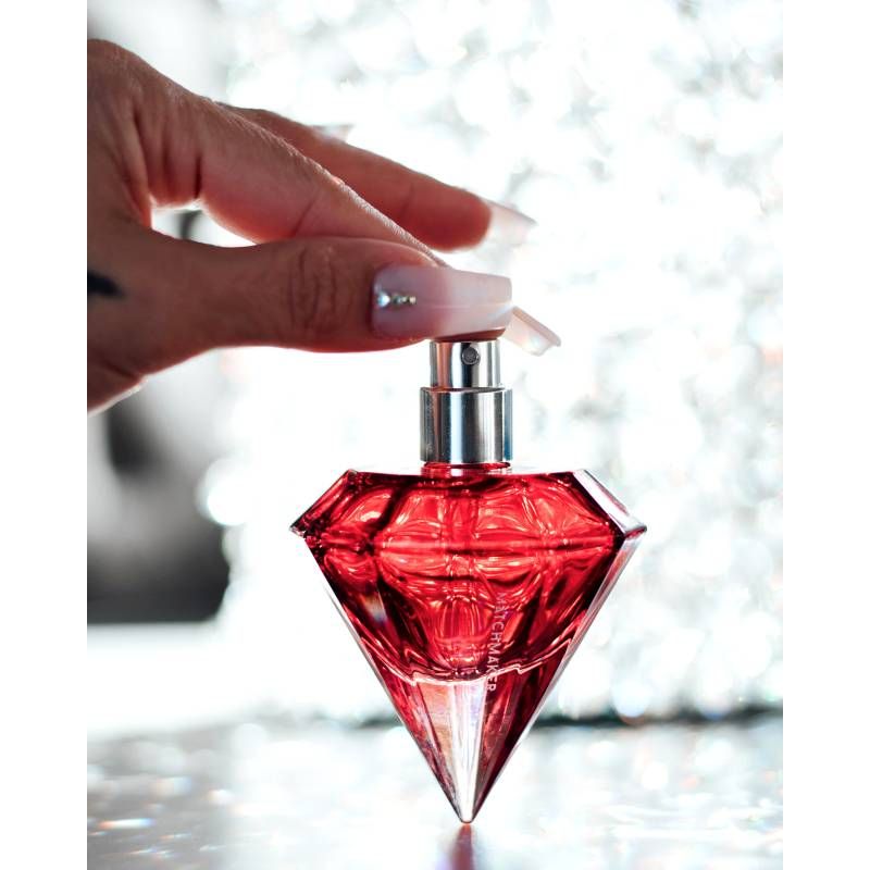 Pheromone body spray for attraction in red diamond-shaped bottle, 30ml, charming and luxurious design.
