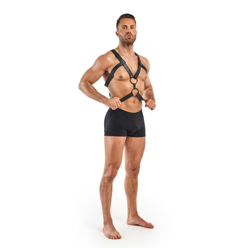 Male model wearing a black adjustable bondage harness, showcasing its adjustable fit and sturdy design.