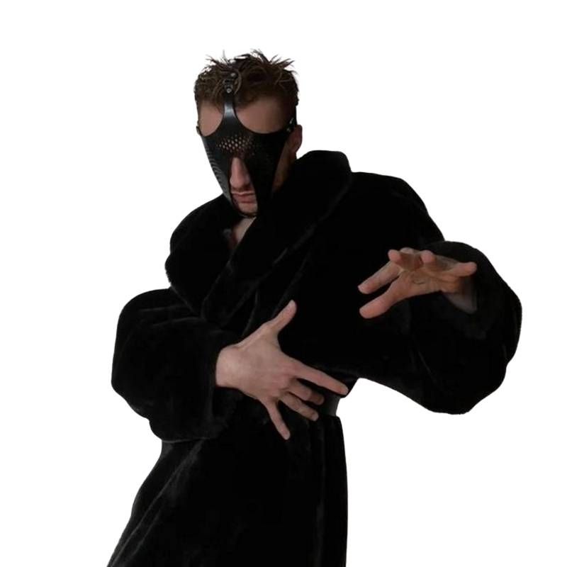 Man wearing Ex Machina genuine leather BDSM role play mask, styled in a fluffy black robe.