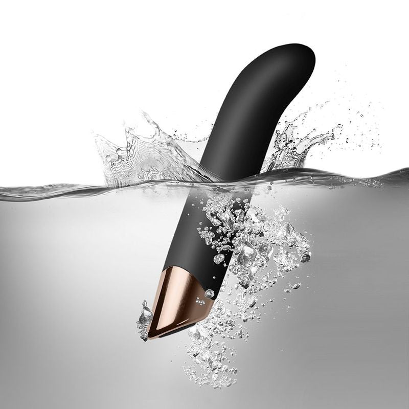 Chaiamo G Black, elegant G spot vibrator showcasing a sleek design, submerged in water with splashes around it.