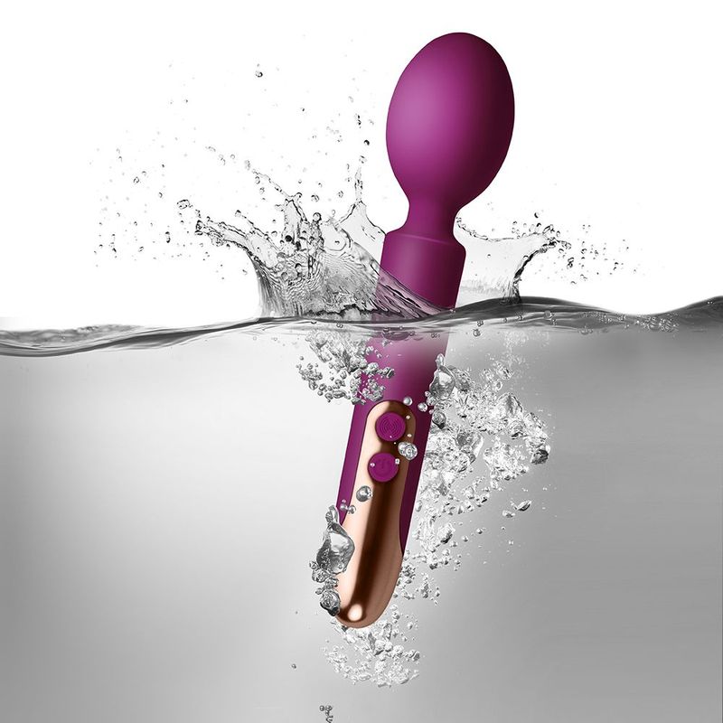 Oriel rechargeable wand massager submerged in water, showcasing its sleek design and waterproof features.