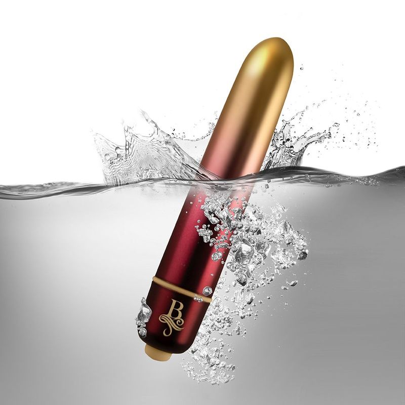 Waterproof bullet vibrator immersed in water with splashing effects, showcasing its sleek design and colors.