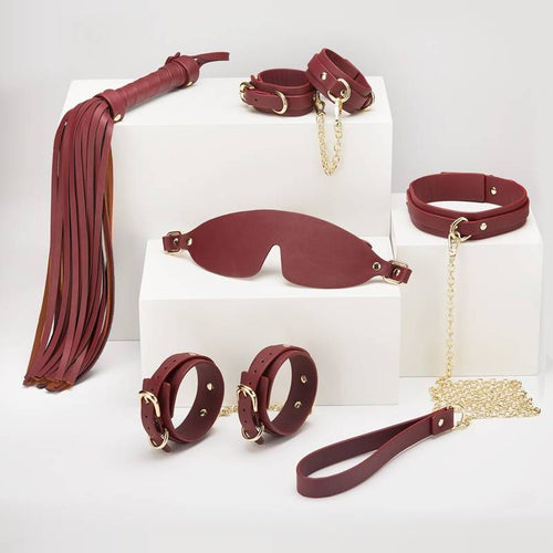 8 Pc Deluxe Bondage Play Kit featuring burgundy faux leather pieces and gold metal trim for erotic play.