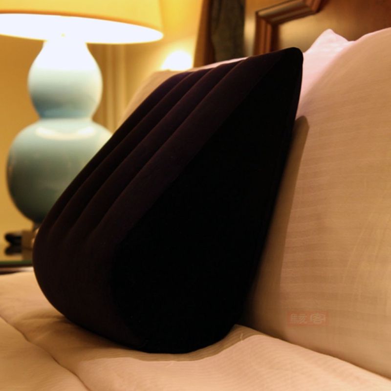 Inflatable sex positioning cushion placed on bed, designed for comfort and better angles in intimacy.