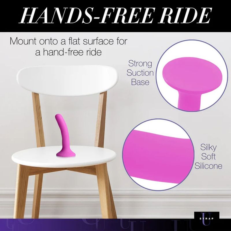 Pink Silicone Strap-On Dildo Small with strong suction base for hands-free pleasure on a chair.