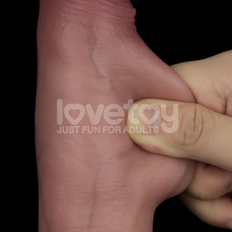 Realistic silicone dildo 8.5in being squeezed to showcase its soft, textured surface and dual-layer design.