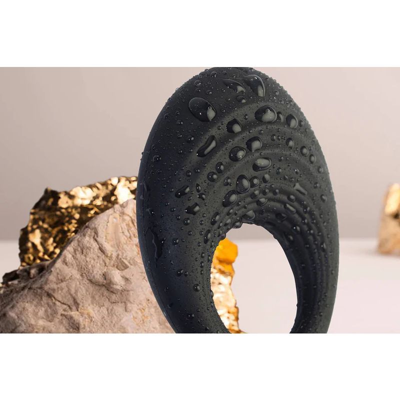 Spire 10 Speed Silicone Vibrating Cock Ring with droplets, showcasing its sleek design and luxurious silicone texture.