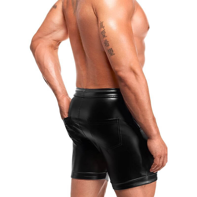 Man wearing Rogue Shorts in black shiny fabric, showcasing a sleek fit and modern design.