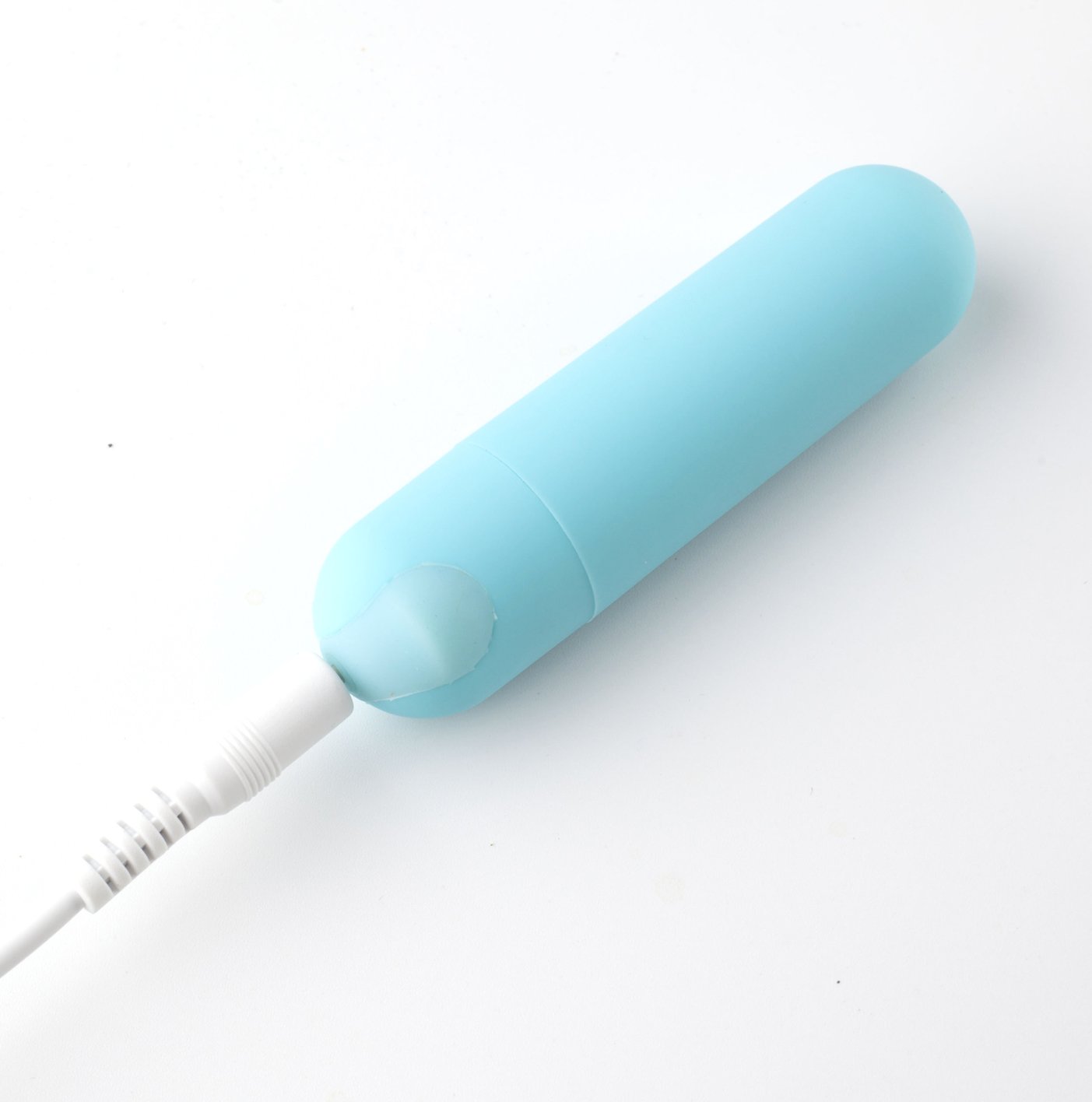 USB rechargeable mini bullet vibrator in teal blue with USB charging cable.