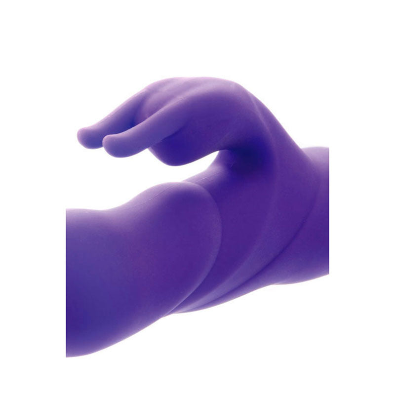 close-up view of the textured surface of a purple rechargeable thrusting rabbit vibrator