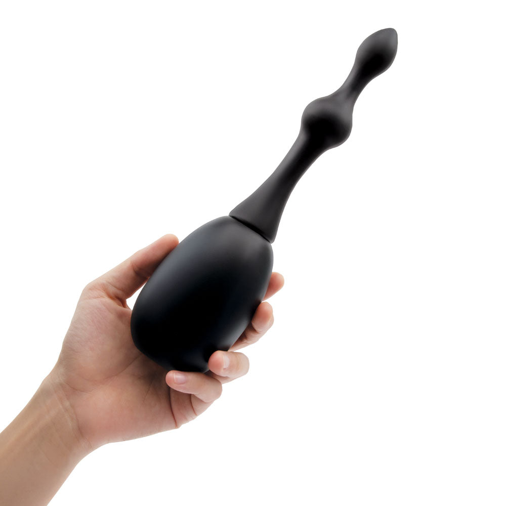 AquaClean Silicone 1-Way Valve Douche Set with Beaded Nozzle - 150 ml Capacity with Free Travel Douche Included in a hand.