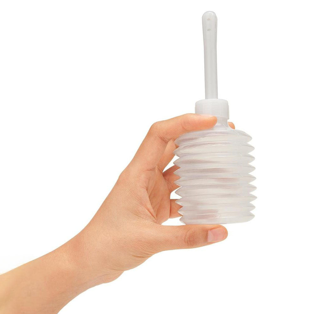 AquaClean 300ml Enema Syringe - 300 ml Capacity with Free Travel Douche Included held in hand.
