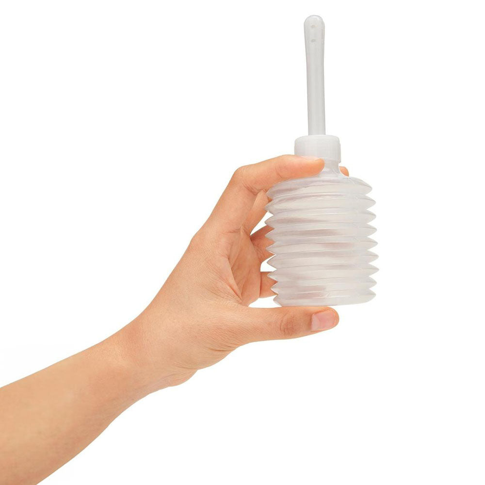 AquaClean Medical Grade Douche Set with 1-Way Valve - 310 ml Capacity with Free Travel Douche Included held in hand.