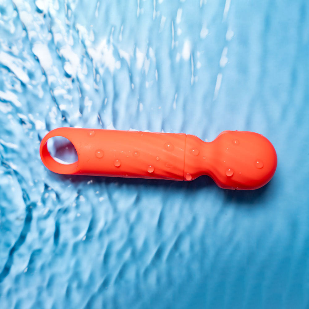 Maia DOLLY - Orange - Orange 12.7 cm USB Rechargeable Massage Wand on a water background
